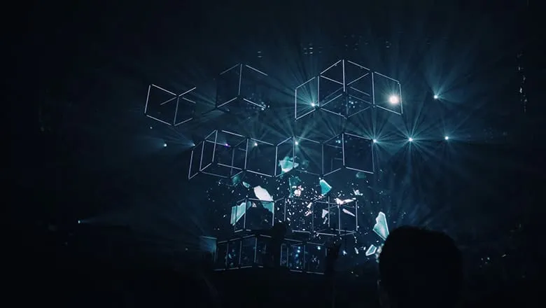Stage with glowing wireframe cubes and light beams