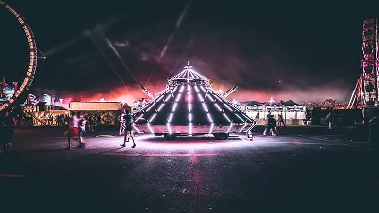 Fairground at night with a brightly lit carousel